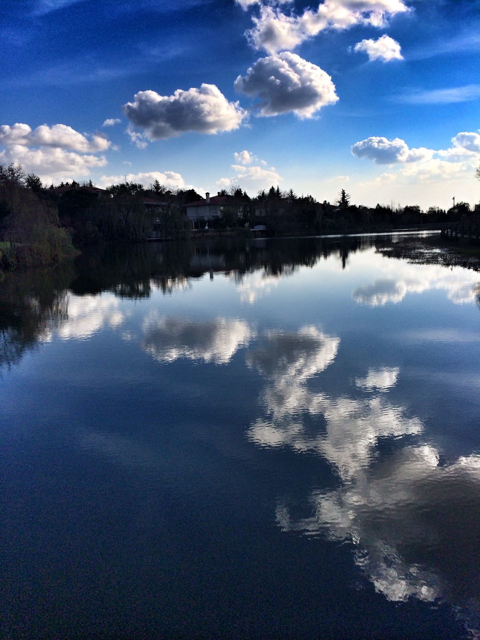 water, reflection, sky, lake, blue, cloud - sky, tranquil scene, tranquility, cloud, scenics, tree, beauty in nature, waterfront, standing water, nature, calm, river, built structure, outdoors, idyllic