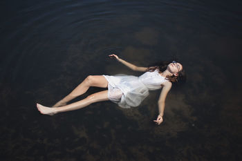 High angle view of woman relaxing in sea