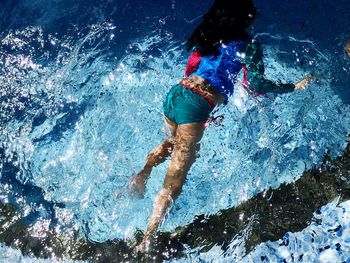 High angle view of girl swimming in pool