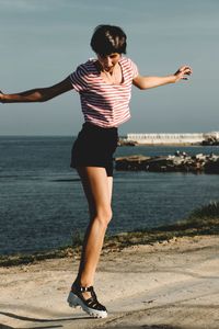 Full length of woman standing on beach