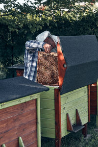 Man holding honeycomb in yard