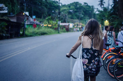 Woman biking on street in village