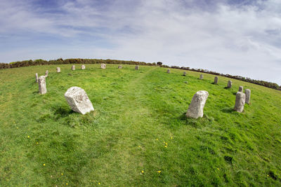 Hay bales on field against sky