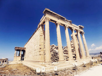 Low angle view of temple against clear blue sky