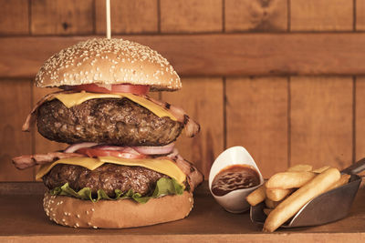 Close-up of a massive double bacon and cheeseburger and fries