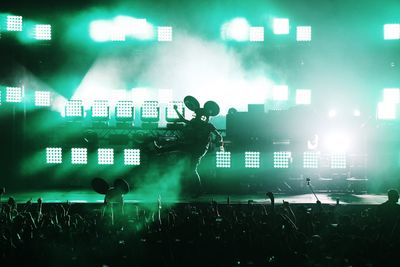 Group of people in front of stage at night