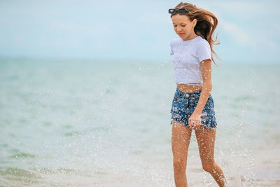 Young woman standing at beach