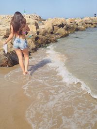 Woman standing on beach