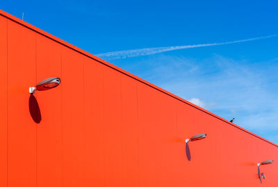 Low angle view of warehouse against blue sky