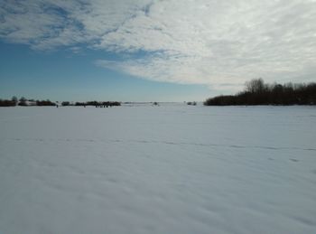 Scenic view of frozen lake against sky during winter