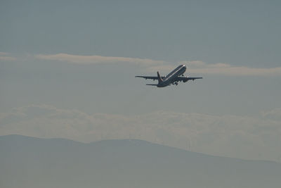Low angle view of airplane flying in sky