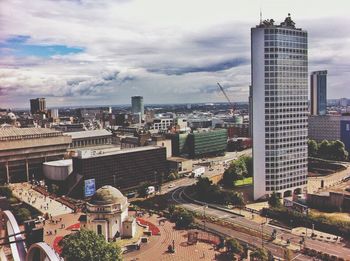 Buildings against cloudy sky