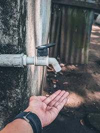 Close-up of man working on wall