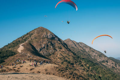 People paragliding against sky