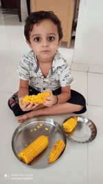 Portrait of boy with ice cream at home