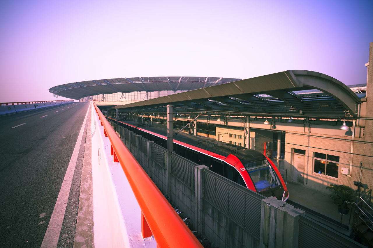 TRAIN ON BRIDGE AGAINST CLEAR SKY IN CITY