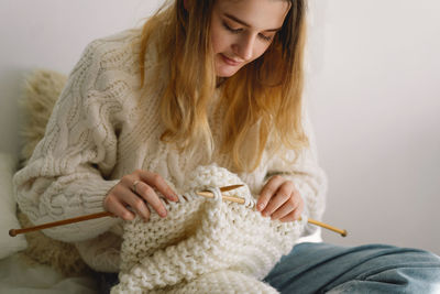 Teengirl knitting at home. handmade and hobby.