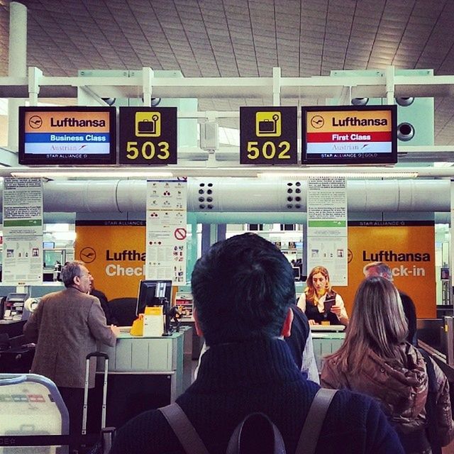 men, communication, transportation, text, public transportation, lifestyles, western script, mode of transport, indoors, rear view, person, passenger, travel, non-western script, journey, information sign, leisure activity, sitting, bus