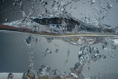 Close-up of bubbles in sea seen through glass