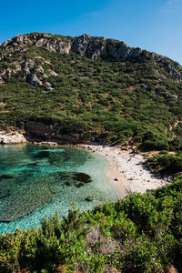 Scenic view of sea and mountains against clear sky