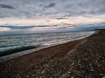 Scenic view of beach against sky during sunset