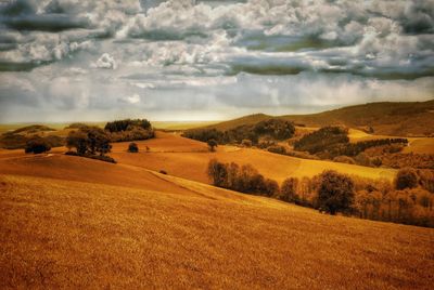 Scenic view of landscape against cloudy sky