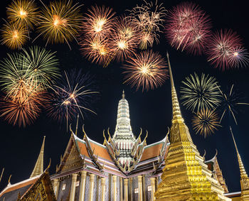 Low angle view of firework display at night