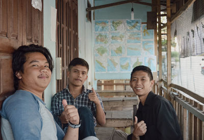 Portrait of smiling friends standing in abandoned house