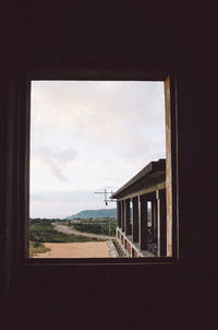 House against sky seen through window