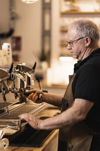 Side view of man working in workshop