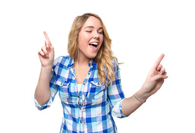 Beautiful young woman standing against white background
