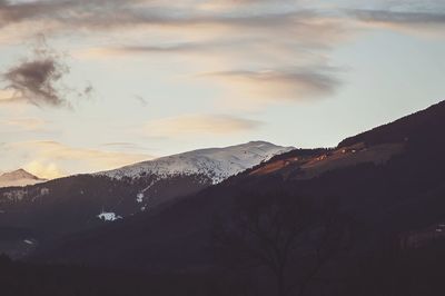 Scenic view of mountains against cloudy sky