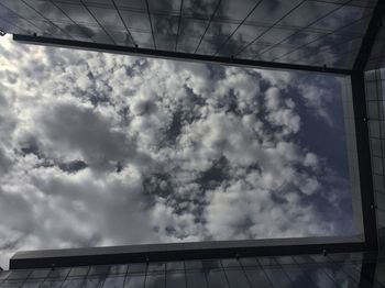 Low angle view of building against cloudy sky