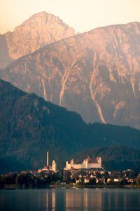 Scenic view of river and mountains against sky