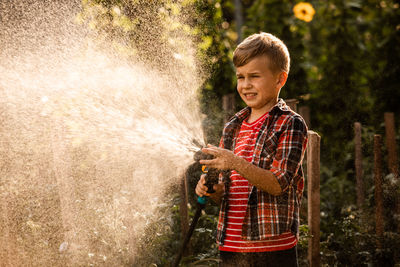 Full length of a boy standing in water