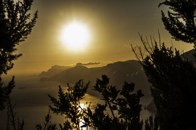 Scenic view of silhouette mountains against sky at sunset