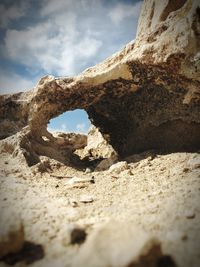 Low angle view of rock formations against sky