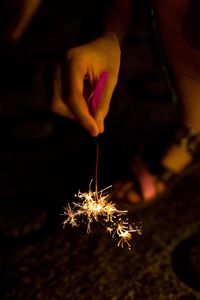 Close-up of hand holding sparkler