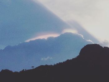 Low angle view of silhouette mountain against sky