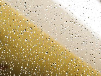 Full frame shot of raindrops on glass window