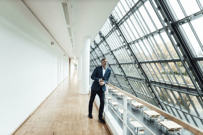 Man walking in corridor of building