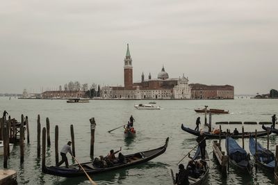 View of boats in city at waterfront