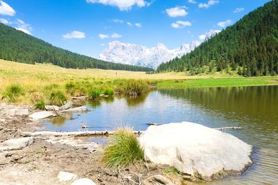 Scenic view of lake and mountains against sky