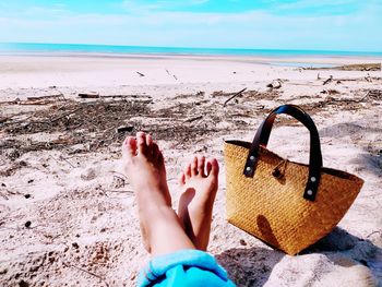 Low section of person relaxing on beach