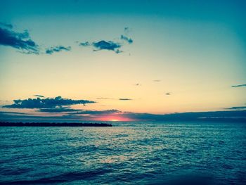 Scenic view of sea against sky at sunset