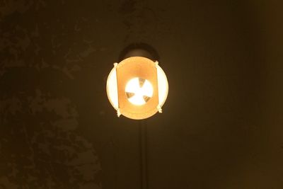 Low angle view of illuminated electric lamp