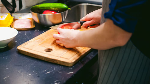 Close-up of person preparing food on cutting board