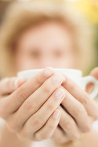 Close-up of woman hand holding cup of drink