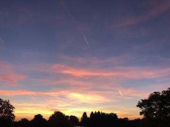 Low angle view of silhouette trees against sky during sunset