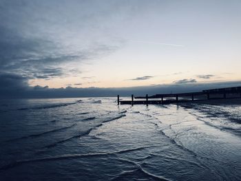 Scenic view of beach against sky during sunset